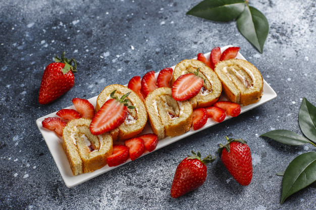 Delicious strawberry cake roll with fresh strawberries,top view